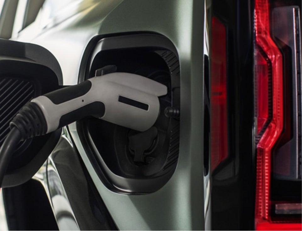 Close up of charging port with charger plugged in on a GMC Hummer EV SUV - Allen Christian GMC in Dexter MO